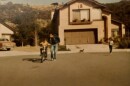 Ricardo Flores rides his bike with his father by their home in Rancho San Diego in 1982.