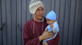 Jose Pedro Rosales Fernandez, 18, from Progreso, Honduras, holds his four-month-old son Dariel, inside the sports complex where thousands of migrants have been camped out for several days in Mexico City, Friday, Nov. 9, 2018. About 500 Central American migrants headed out of Mexico City on Friday to embark on the longest and most dangerous leg of their journey to the U.S. border, while thousands more were waiting one day more at a massive improvised shelter.