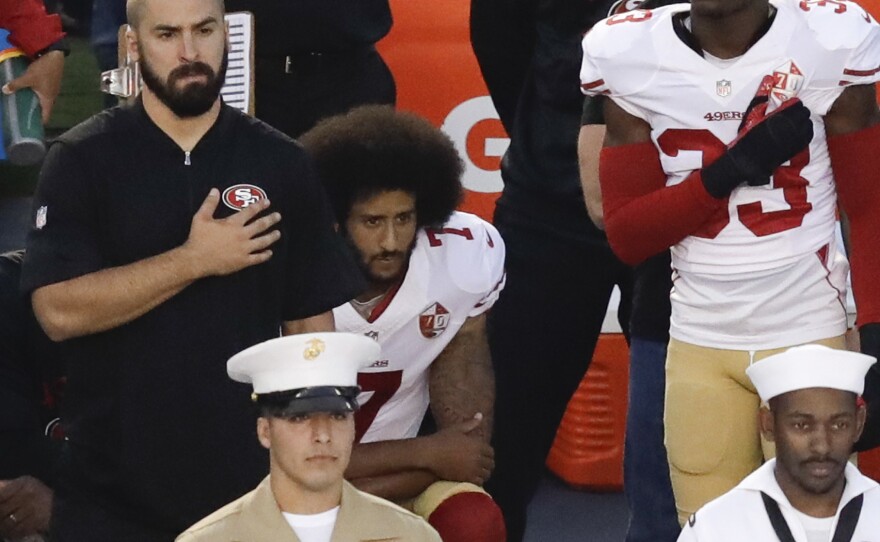 Colin Kaepernick, quarterback of the San Francisco 49ers, kneels during the national anthem before Thursday night's game in San Diego.