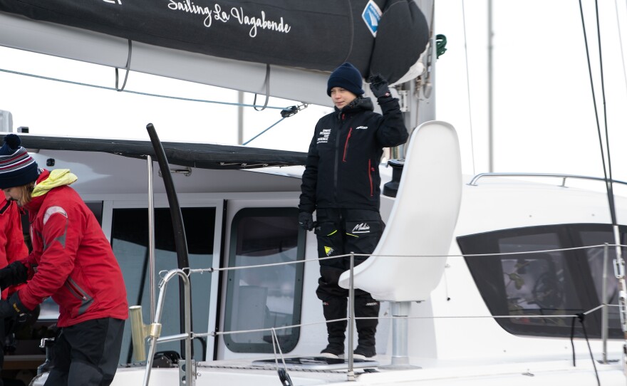 Swedish climate activist Greta Thunberg waves aboard the catamaran La Vagabonde as she sets sail for Europe from Hampton, Va., on Wednesday.