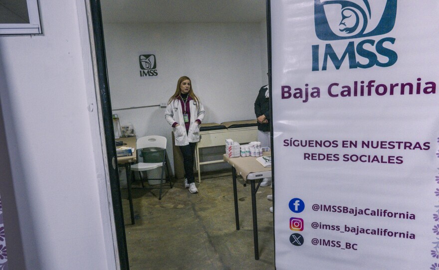 A woman in a medical coat stands inside the medical office in a new shelter for deportees in Tijuana, Mexico, Jan. 25, 2025