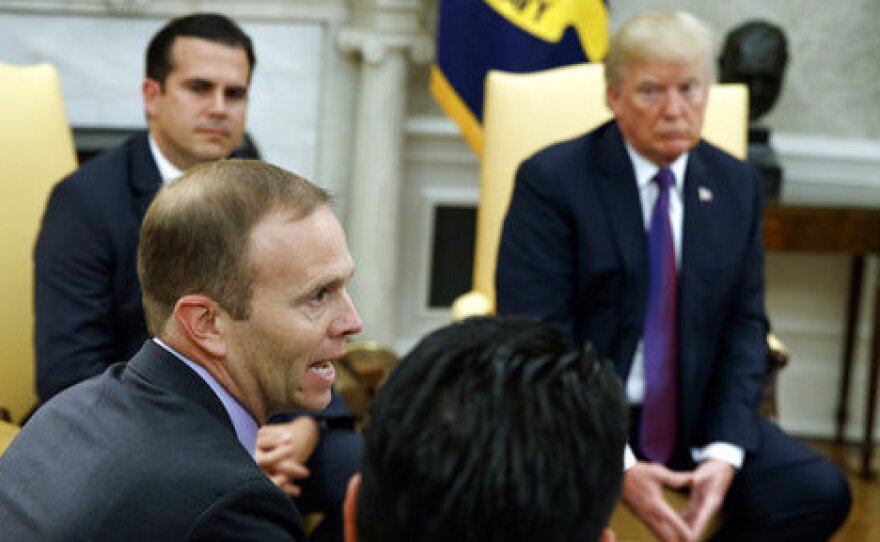 President Trump and Puerto Rico Gov. Ricardo Rossello listen as FEMA Administrator Brock Long speaks during a meeting in the Oval Office on Thursday.