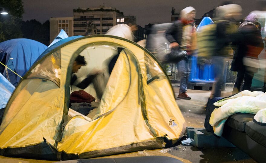 The Stalingrad Connection community radio station was named for the Paris metro stop where migrants camped out back in 2016. Above, migrants are shown during an evacuation outside the Stalingrad station on Nov. 4, 2016.