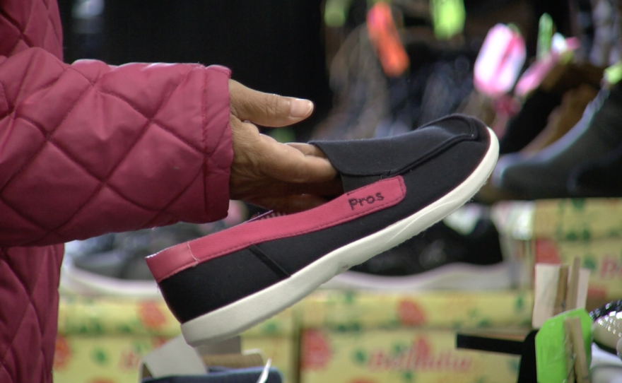 Mexican shopper Delia Frasco looks at shoes at Carolin Shoes Inc., Feb. 20, 2017. 