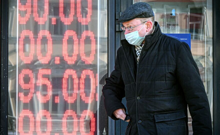 A man walks past a currency exchange office in central Moscow on Feb. 28, 2022. The U.S. and its allies have imposed severe sanctions on Russia since its invasion of Ukraine.