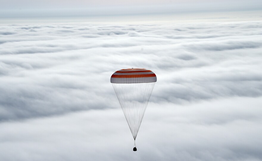 The Soyuz TMA-18M capsule carries International Space Station crew members Scott Kelly, Mikhail Kornienko and Sergei Volkov before landing in Kazakhstan.