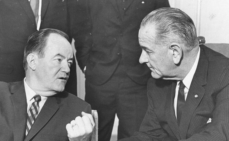President Lyndon B. Johnson (right) listens to Vice President Hubert H. Humphrey's report of his five-day Far East tour, Jan. 3, 1966.