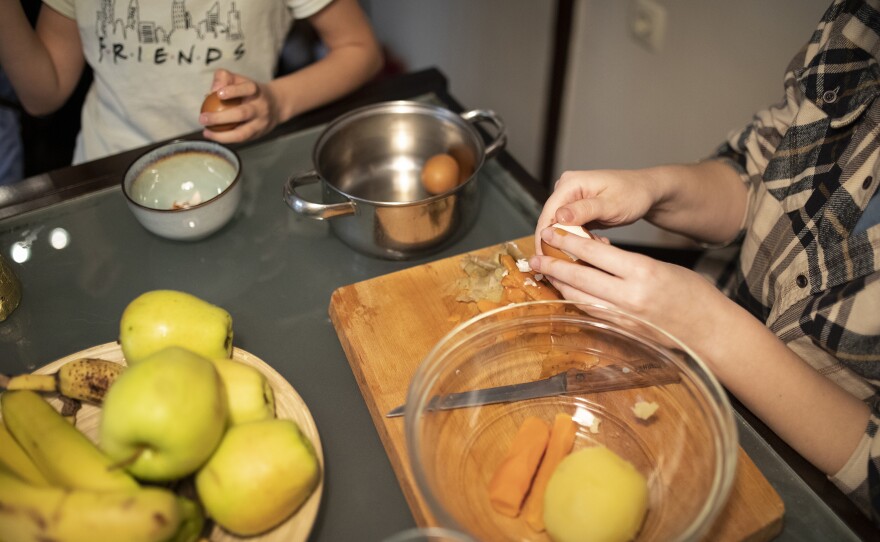 Oleksandra Nykolyn, left, and Anet Pchelnikova, right, prepare dinner at their apartment in Sofia, Bulgaria, on Friday, April 22.