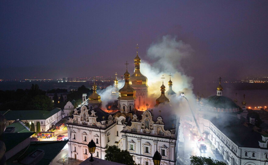 Rescue workers try to put out a fire at the Dormition Cathedral of thousand-year-old Monastery of Caves, also known as Kyiv Pechersk Lavra, following a Russian strike on Kyiv, Ukraine, Monday, June 15, 2026.