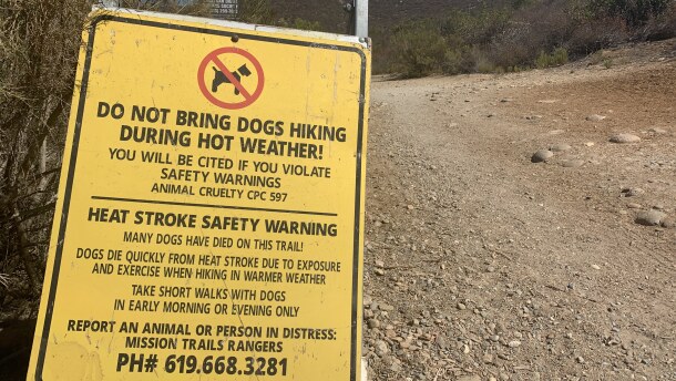 A sign says "do no bring dogs hiking during hot weather!" at a trail on Cowles Mountain in San Diego, Calif. Aug. 3, 2021. 