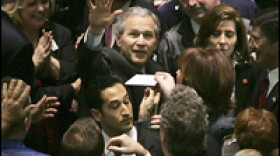 I'll Take Five: President Bush visits traders on the floor of the New York Stock Exchange. Later, he delivered a speech on the economy.