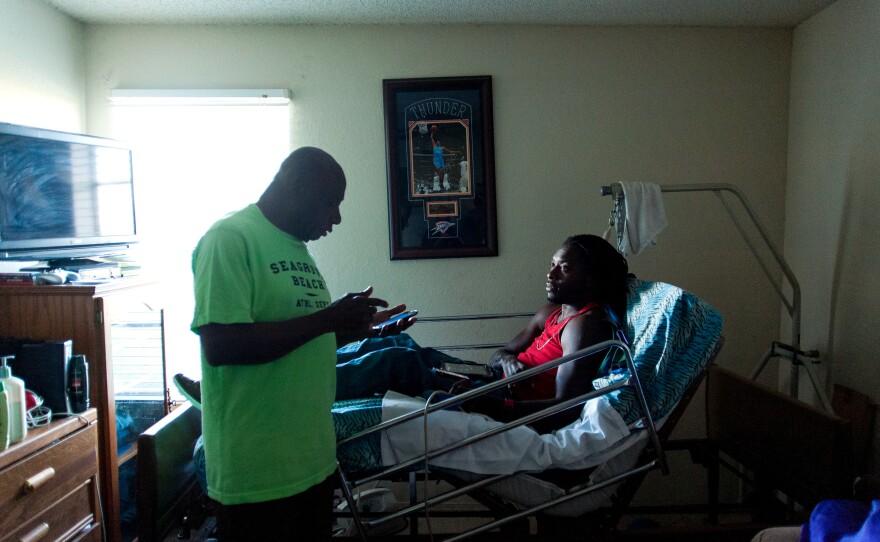 Nnaka's father, Phillip, asks him for help figuring out a problem he is having with his phone in the apartment they share.