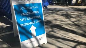 A sign directs visitors to the staff entrance at the UC San Diego vaccination super station in La Jolla, San Diego on Feb. 20, 2021.