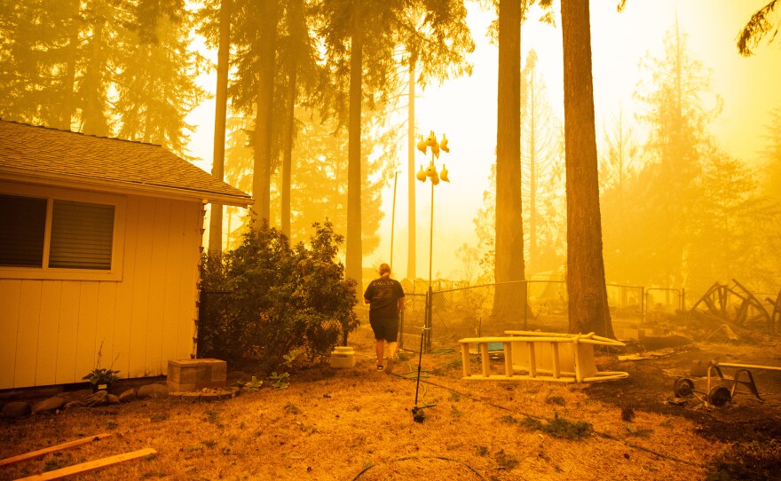 Chelsea DeVos scrambles to salvage possessions from her home as the Santiam Fire approaches near Gates.