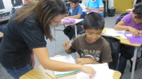 Teacher Annie Bhatnager helps a student with an assignment in the Newcomer class during the first week of school.