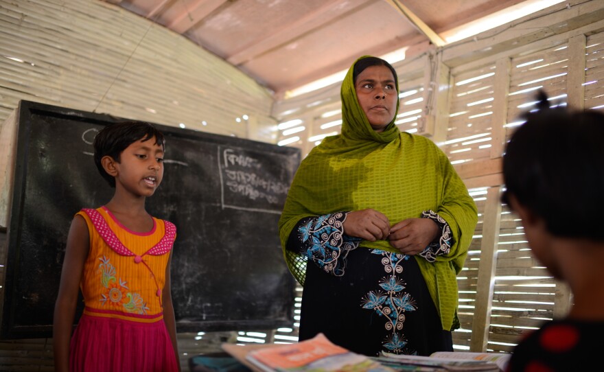 Nila Khatun, age 8, and her teacher, Mafya Begum, during a lesson on the floating school.