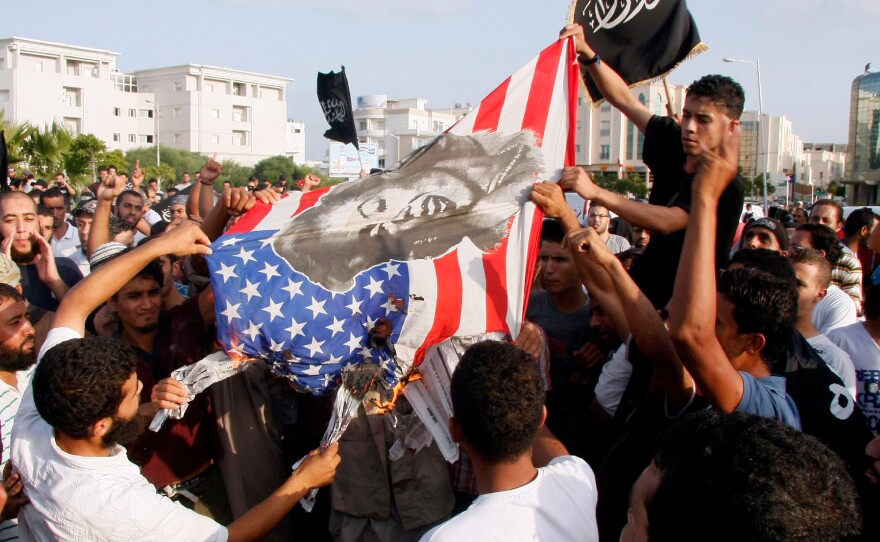 Tunisian protesters burn a U.S. flag bearing a portrait of actress Marilyn Monroe during a demonstration against the film Innocence of Muslims outside the U.S. embassy in Tunis in September 2012. The anti-Islam film sparked protests at many U.S. embassies in the Muslim world.