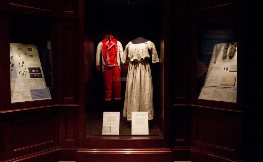 Reproductions of the types of clothing slaves wore in the mansion (center left) and in the fields (right) at Mount Vernon are on display at the exhibit.