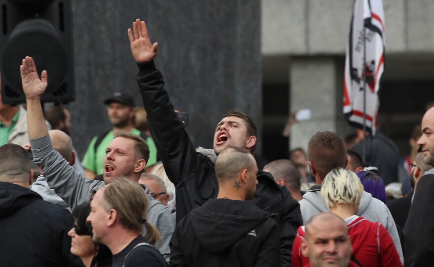 A man raises his arm in a Nazi salute in response to heckling from leftists at a protest gathering the day after a fatal stabbing by migrant suspects triggered large protests in the city of Chemnitz in eastern Germany.