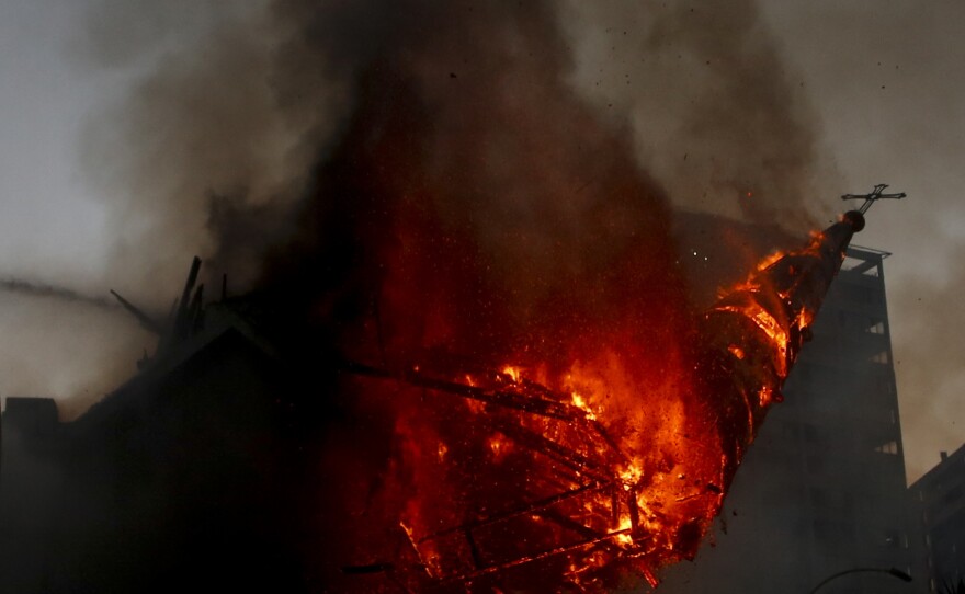 The dome of La Asunción church collapses after it was attacked and set on fire on the first anniversary of the outbreak of anti-government mass protests over inequality in Santiago, Chile, on Oct. 18.