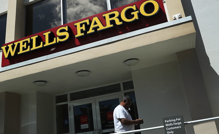 A Wells Fargo executive's departure with large stock and options holdings has sparked questions, after the division she ran incurred $185 million in penalties.