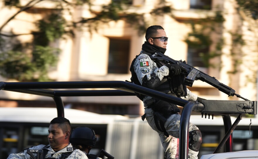 Security personnel guard the prosecutor's building where Ovidio Guzmán, one of the sons of former Sinaloa cartel boss Joaquin "El Chapo" Guzmán, is in custody in Mexico City, Thursday, Jan. 5, 2023.