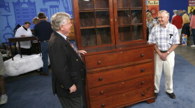 At "Antiques Roadshow" in San Antonio, Texas, this man brings in a gigantic Texas desk and bookcase, circa 1850. After a careful examination, appraiser Dean Failey of Christie's connects this piece to the growing population of German cabinetmakers in Texas during the 1840s. The proud owner stands tall next to this formidable piece of furniture, as Failey estimates its value at $7,000 to $10,000.