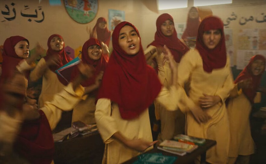 One scene from the video is set in a school, with the girl students wearing hijabs.