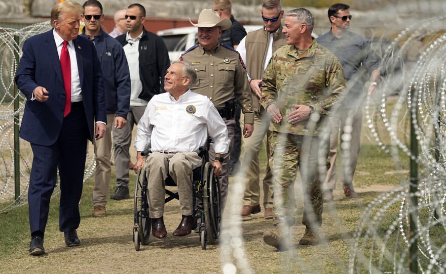 Former President Donald Trump talks with Texas Gov. Greg Abbott during a visit to the border at Eagle Pass, Texas on Feb. 29.