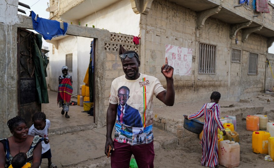 A supporter of Senegalese presidential candidate, Amadou Ba of Senegalese President Macky Sall's ruling coalition, reacts as he wear a T-shirt depicting Ba in Fass Boye, Senegal March 20, 2024.