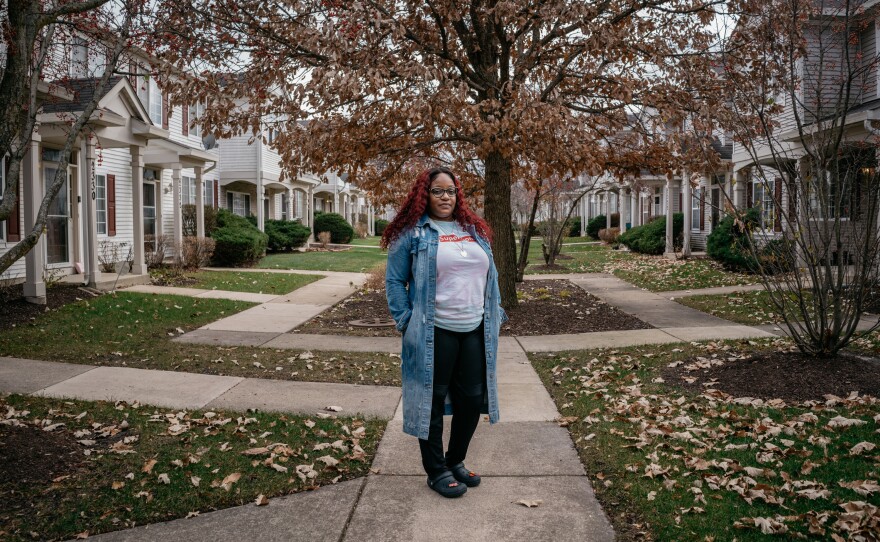 Cassie by her home in Aurora, Illinois. Before moving to a subdivision she would take her daughters to trick or treat there, she dreamed of one day living in a neighborhood like it.