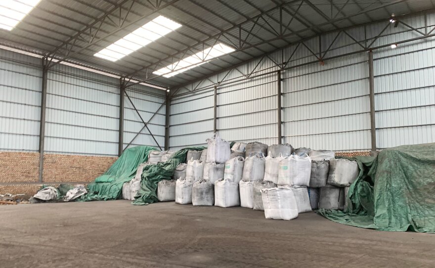 Sacks of coal byproducts await sale at a manufacturing site in northwestern China's Ningxia region, where Benjamin Chen works as a salesperson.