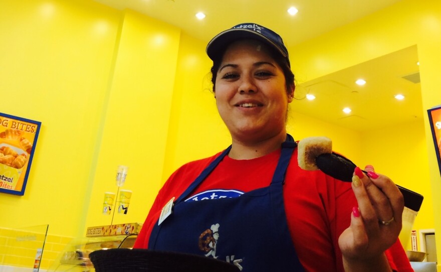 Wetzel's Pretzels employee Emperatriz Orozco hands out free samples at the Westfield Valley Fair Mall.