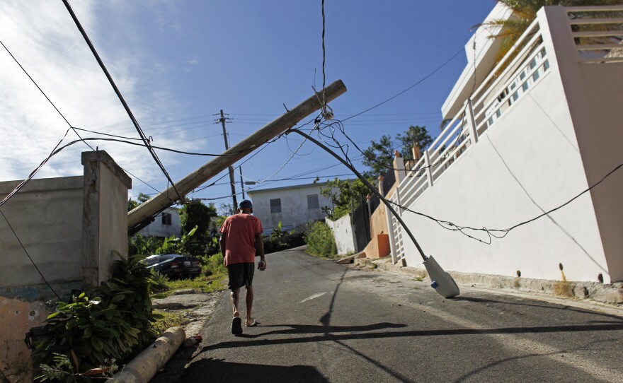 A man walks under a downed light post in Vieques, Puerto Rico.