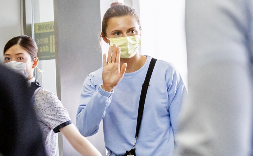 Belarusian athlete Krystina Tsimanovskaya was offered a humanitarian visa by Poland, after her country's officials tried to force her to take an early flight home from the Tokyo Olympics. She's seen here boarding a flight to Austria from the Narita international airport in Tokyo, Japan.
