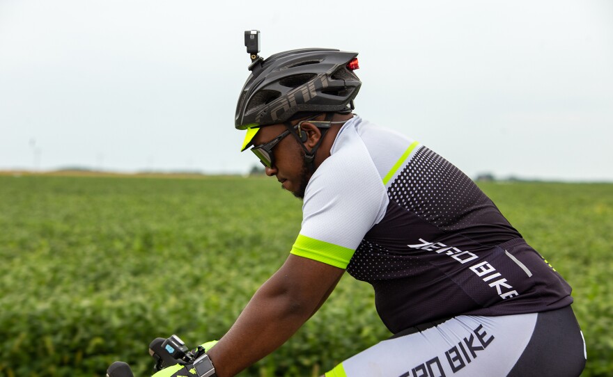 Son, Eric, riding his bike with the corn fields in the background.