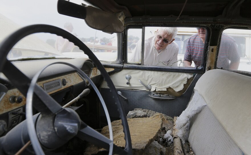 Car buffs look at a 1956 Chevrolet Bel Air four-door sedan during a preview for an auction of vintage cars and trucks from the former Lambrecht Chevrolet dealership Friday.