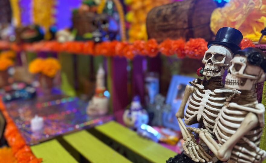 Two embracing skeletons sit on an altar at the Sherman Heights Community Center on Oct. 15, 2025