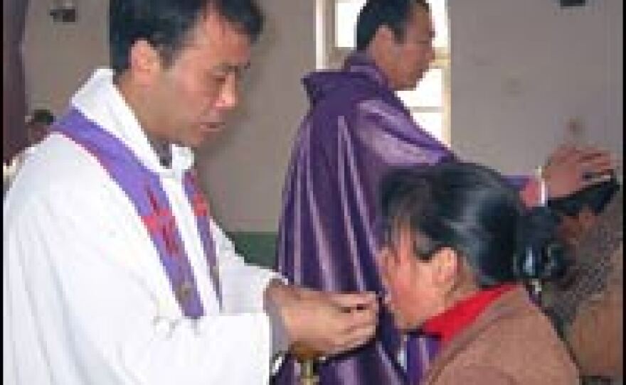 Bishop Feng (in purple) and a local priest distribute the Eucharist. Most of the congregation members at the Hengshui diocesan church are farmers.