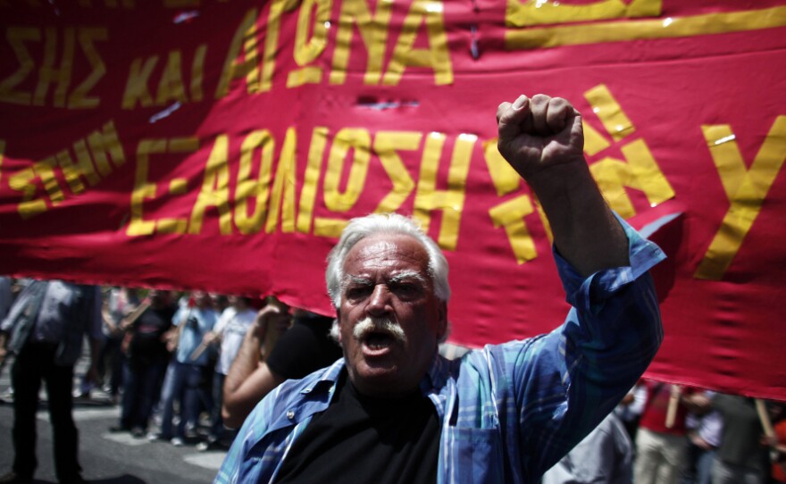 A protester shouts slogans during a May Day protest in Athens on Tuesday. In debt-crippled Greece, more than 2,000 people marched through central Athens in subdued protests centered on the country's harsh austerity program, ahead of elections scheduled for May 6.