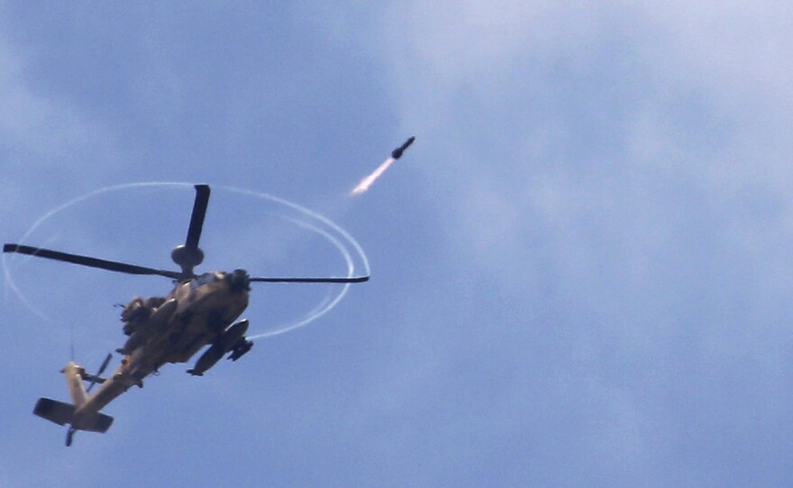 An Israeli Apache helicopter fires a missile towards the Gaza Strip on Saturday as  Israeli forces pressed ahead with a ground offensive.