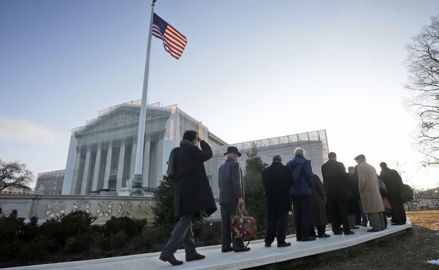 People file into the Supreme Court on Tuesday for the court's hearing on California's Proposition 8, a voter-approved ban on same-sex marriage.
