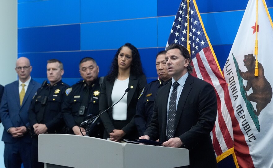 Matt Cobo, F.B.I. San Francisco Acting Special Agent in Charge ( right) speaks next to San Francisco Police Chief Derrick Lew (second from right) and San Francisco District Attorney Brooke Jenkins (third from right) during a news conference Monday, April 13, 2026, in San Francisco.