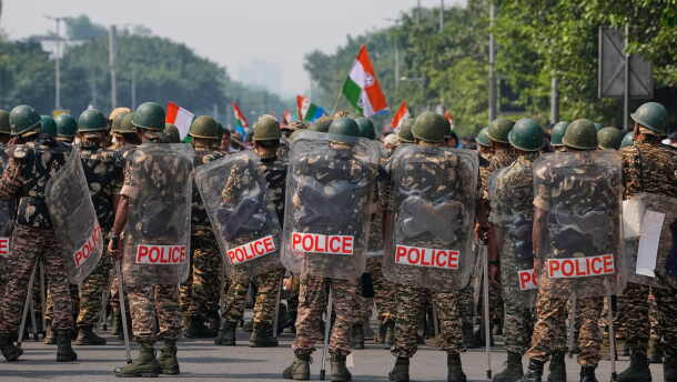 Security personnel in riot gear arrive to escort workers of India's opposition Congress party as they gather for a march toward the Supreme Court demanding the resignation of Chief Election Commissioner Gyanesh Kumar in New Delhi, India, on Monday.