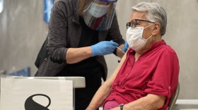 A patient gets vaccinated against COVID-19 at Border View Family YMCA in Otay Mesa, Calif. Feb. 24, 2021.