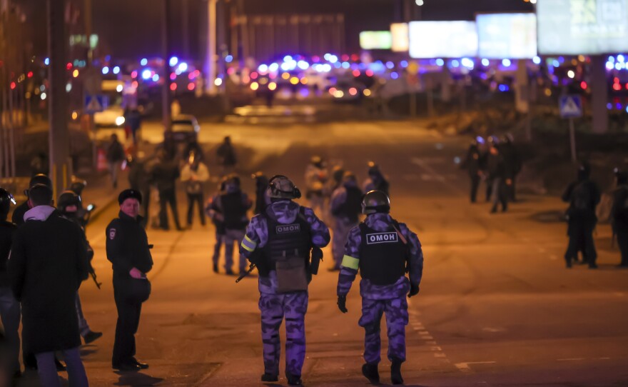 Russian Rosguardia (National Guard) servicemen secure an area near the Crocus City Hall on the western edge of Moscow, Russia, Friday, March 22, 2024. Several gunmen have burst into a big concert hall in Moscow and fired automatic weapons at the crowd, injuring an unspecified number of people.