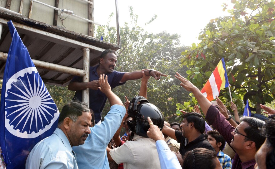 Dalit activists argue with a police officer during a protest on Western Express Highway in Mumbai on Jan. 4, 2018.
