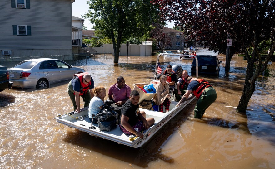 Members of the fire department in Lodi, N.J., perform water rescues of trapped residents following torrential rains from the remnants of Hurricane Ida on Thursday.