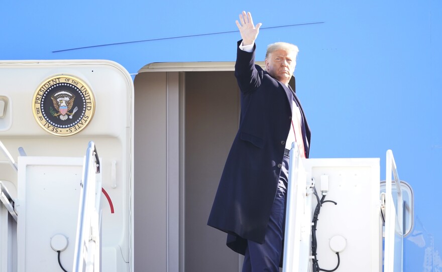 President Donald Trump waves while boarding Air Force One at Joint Base Andrews before a Jan. 12 trip to Texas. He's planning a departure ceremony there on Wednesday, while skipping the traditional send-off at the Capitol.