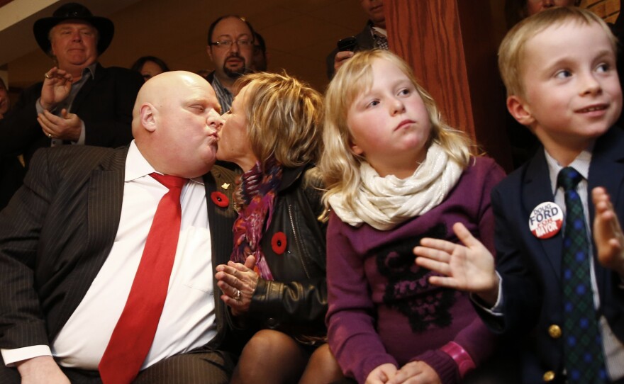 Mayor Rob Ford, left, kisses his wife, Renata, as his children Doug and Stephanie watch the municipal election results Monday in Toronto. Ford dropped his reelection bid after being diagnosed with cancer earlier this year. He appears to have lost hair since then, but on Monday night won the city council seat that his brother Doug vacated to fill Rob Ford's slot in the mayoral race.